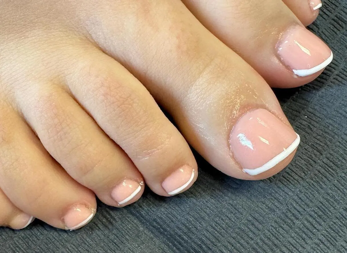 Client with french manicure on toes by Jodie Leslie.